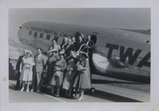 Untitled [Crowd stands outside airplane that reads The Transcontinental Line TWA]