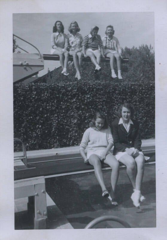 Untitled [Six women sit on diving boards]