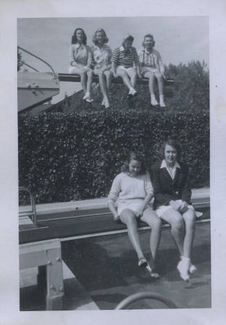 Untitled [Six women sit on diving boards]