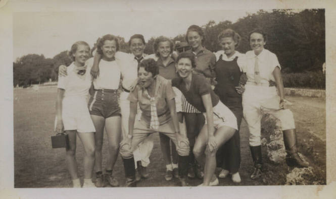 Untitled [Nine women stand on field]
