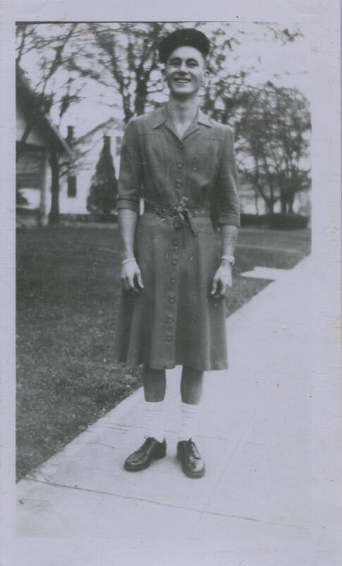 Untitled [Man stands on street, hands by sides]