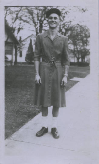 Untitled [Man stands on street, hands by sides]