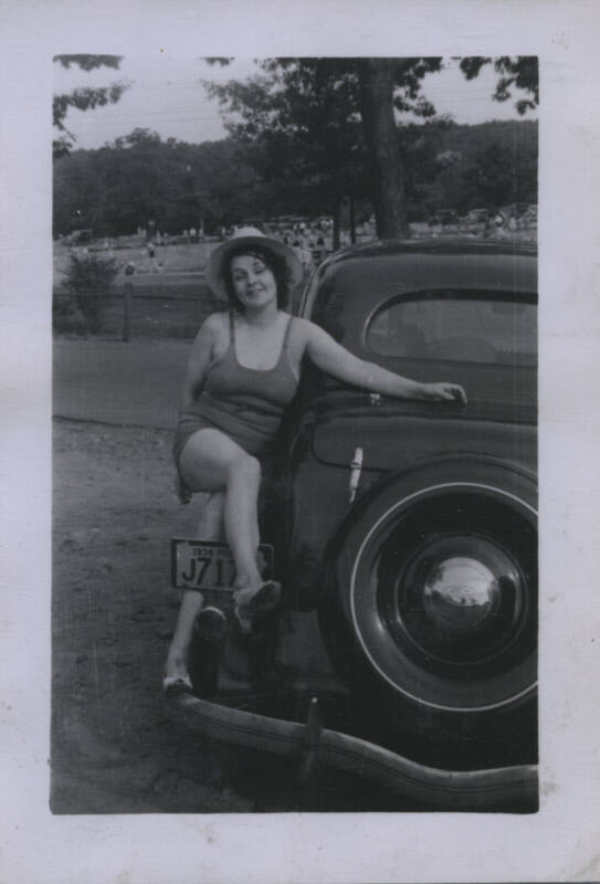 Untitled [Woman sits on car whose plates read 1938 PE J717]