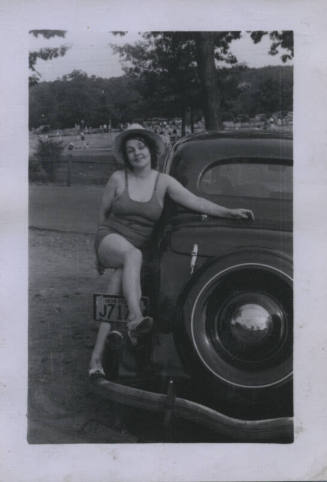 Untitled [Woman sits on car whose plates read 1938 PE J717]