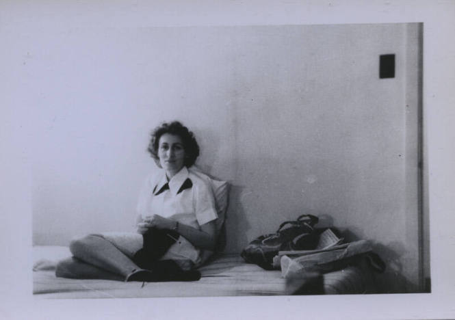 Untitled [Woman sits in bed, knits]