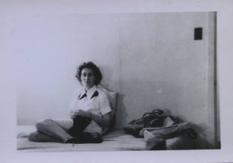 Untitled [Woman sits in bed, knits]