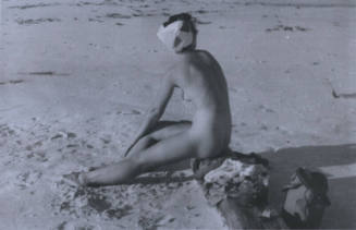 Untitled [Woman sits on log in beach]