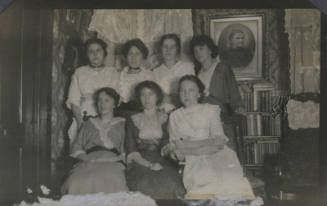 Untitled [Seven women sit and stand together]