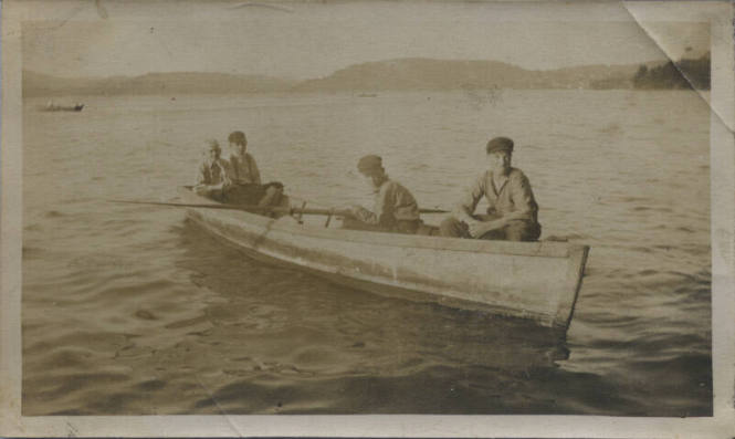 Untitled [Four men sit on a boat]