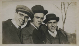 Untitled [Three men wear hats, tree in the background]