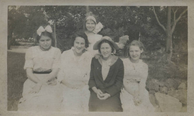 Untitled [Five women sit and stand together]