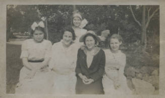 Untitled [Five women sit and stand together]