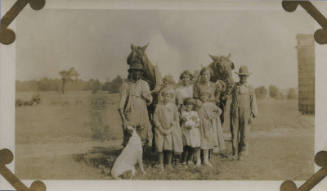 Untitled [Two women, a man, and five children stand with two horses, a cat, and a dog]