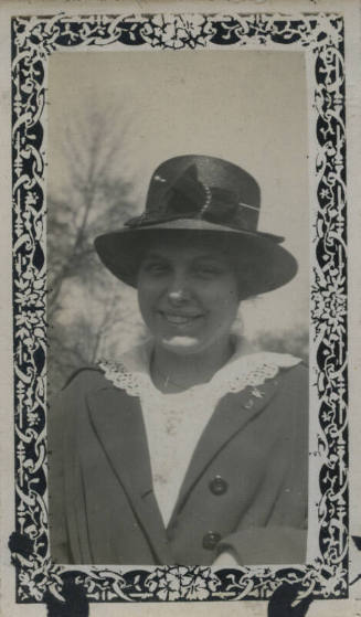 Untitled [Woman wears hat and embroidered collar shirt]