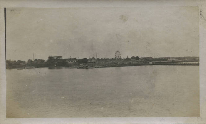 Untitled [Body of water and wheel of fortune in the distance]