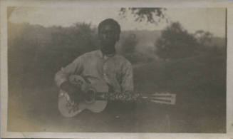 Untitled [Man holds guitar]