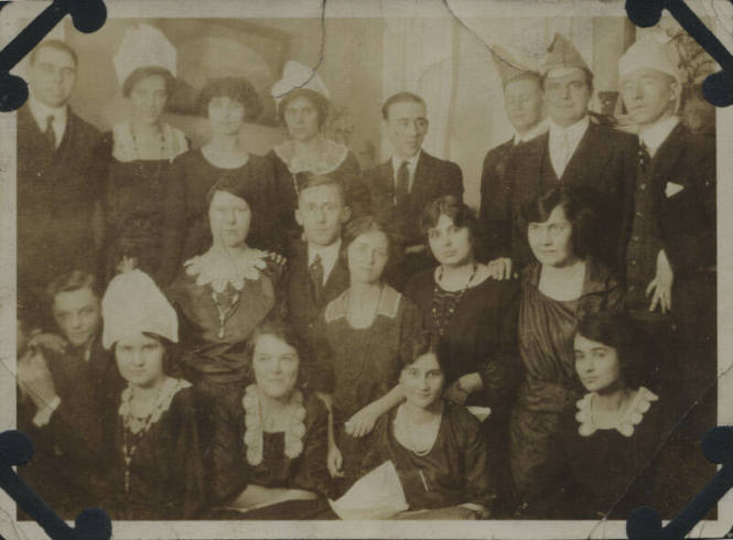 Untitled [Nineteen people sit and stand together]