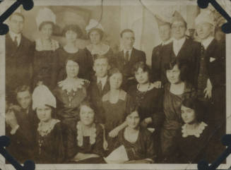 Untitled [Nineteen people sit and stand together]