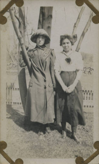 Untitled [Two women stand in front of tree]