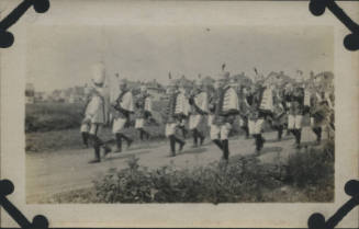 Untitled [Marching band walks down road]