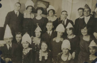 Untitled [Eighteen people sit and stand together]