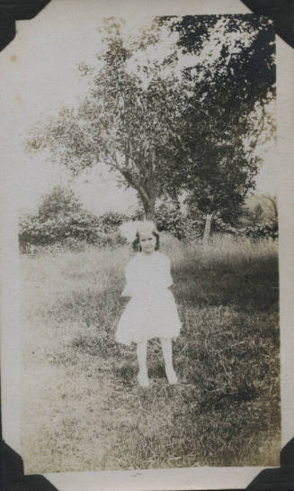 Untitled [Child stands on field]