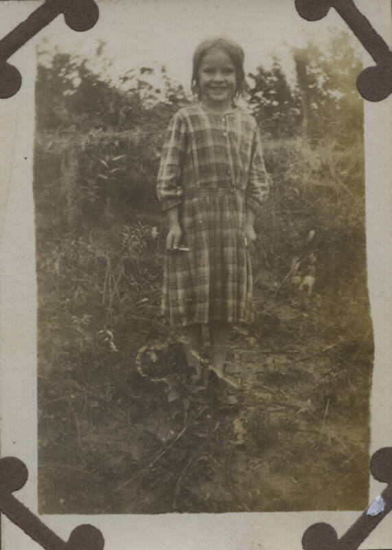 Untitled [Child stands on field]