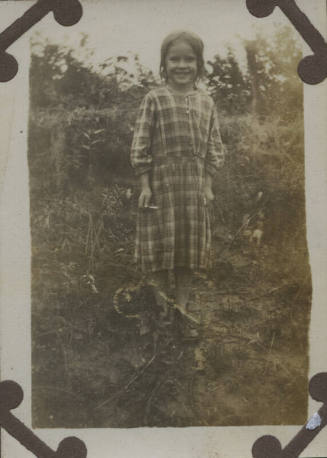 Untitled [Child stands on field]