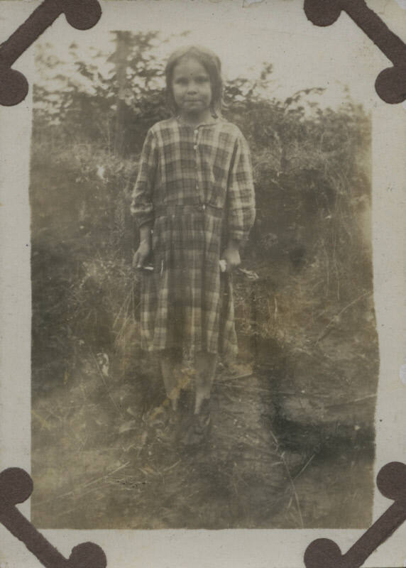 Untitled [Child stands on field]