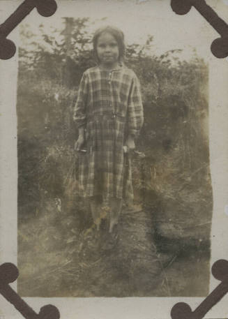 Untitled [Child stands on field]