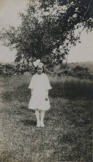 Untitled [Child stands on field]
