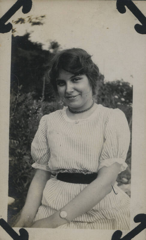 Untitled [Woman sits on lawn]