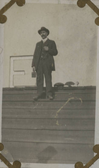 Untitled [Man stands on bleachers, holds camera (#87 duplicate)]