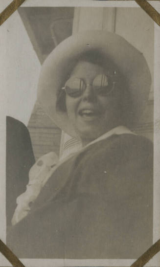 Untitled [Woman wears hat and sunglasses]