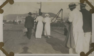 Untitled [Crowd walks down dirt road]