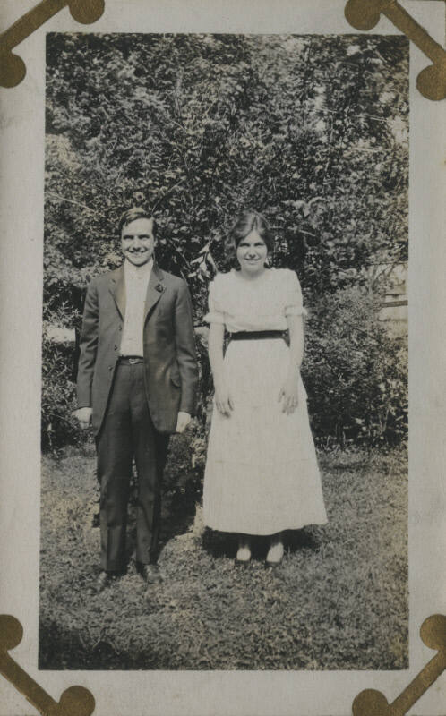 Untitled [Woman and man stand on lawn]