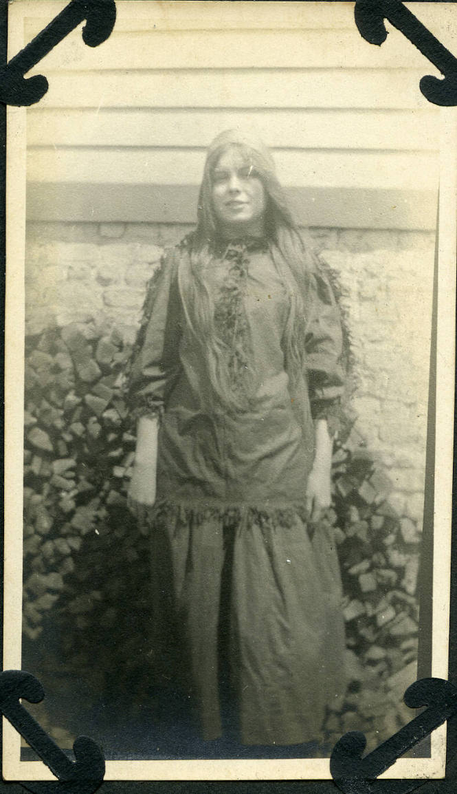 Untitled [Woman stands, arms by her side]