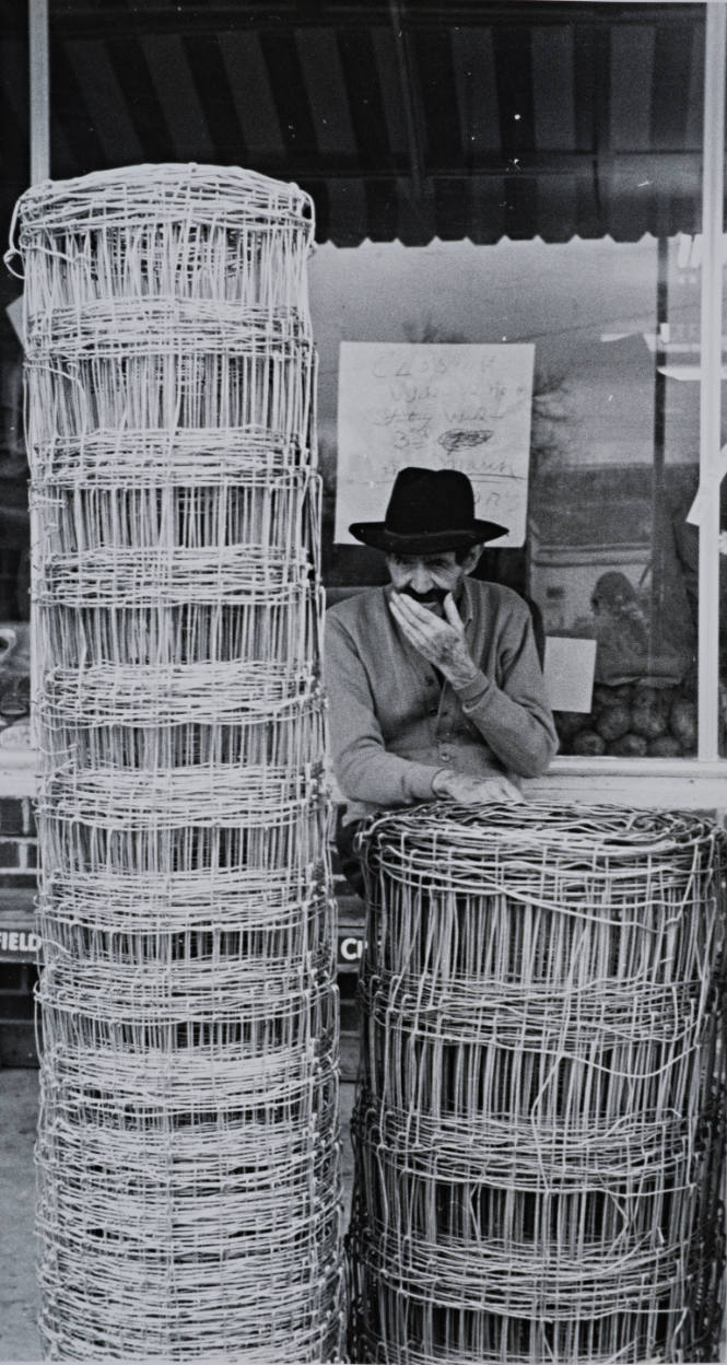 Man and Rolls of Wire Fencing, Mississippi