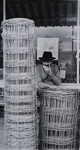 Man and Rolls of Wire Fencing, Mississippi