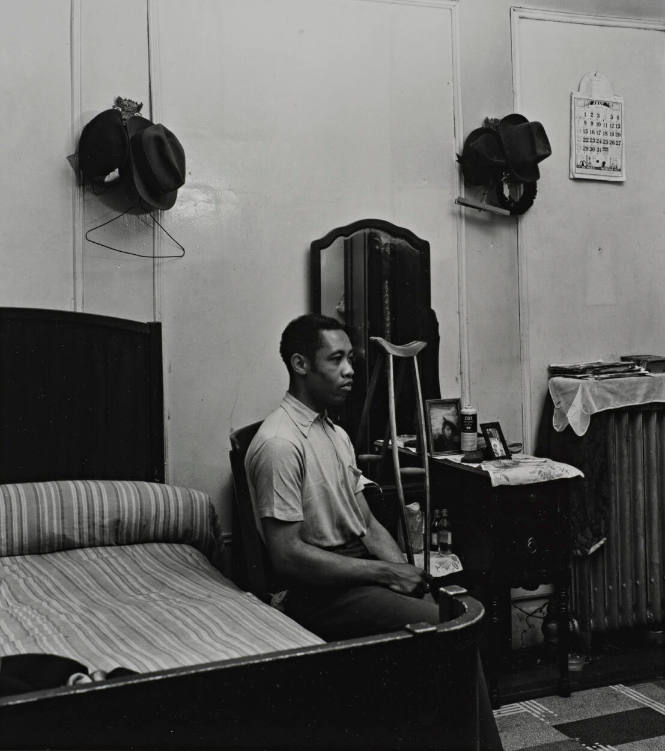 Untitled [3/4 view of sitting man in bedroom with crutch], from the series Harlem Document