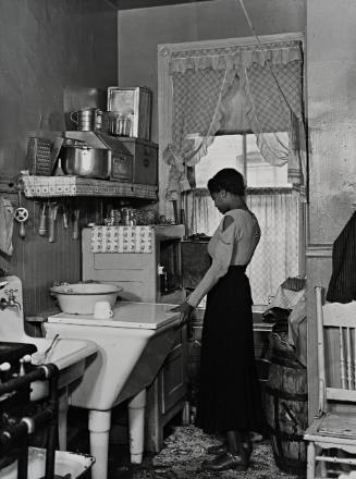 Untitled [Lady in kitchen], from the series Harlem Document