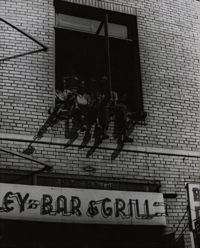Watching a Parade form a Harlem Window