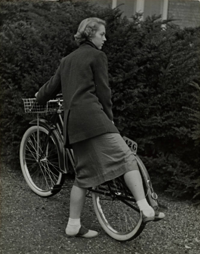 Student working kickstand on bike, Vassar College