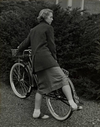 Student working kickstand on bike, Vassar College