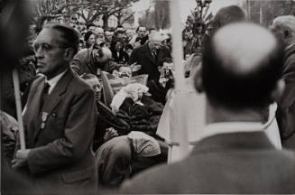 Men with cameras in crowd of pilgrims, Lourdes