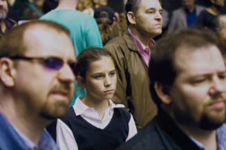 [Girl amid onlookers]