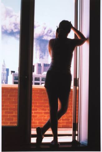 [Woman on cell phone watches fire]