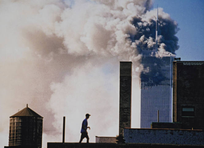 [Man on rooftop before burning North Tower]
