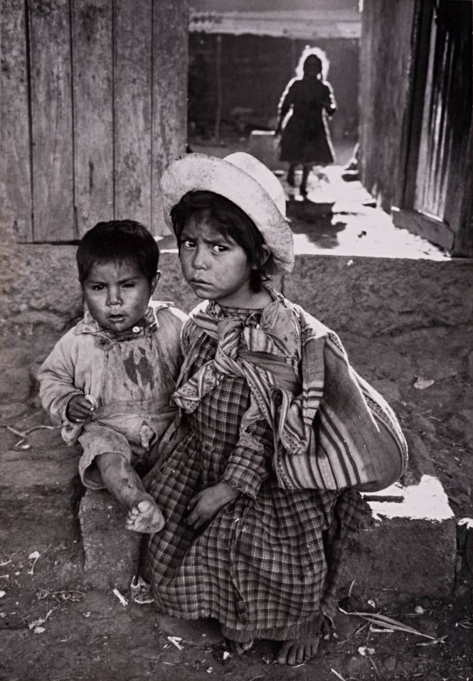 Mexico, Mexican sister and brother in slum area outside Mexico City – taken during 1957 trip with Dr. Margaret Mead (Two children seated in alley)