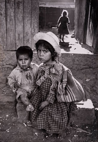 Mexico, Mexican sister and brother in slum area outside Mexico City – taken during 1957 trip with Dr. Margaret Mead (Two children seated in alley)
